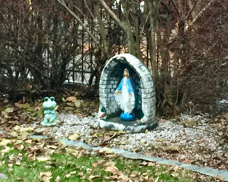 statue of Mary and frog figurine in backyard