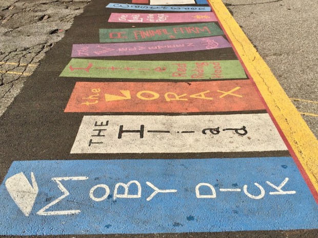 street crosswalk mural of books on a shelf