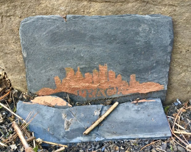 stencil of Pittsburgh skyline with word "Peace"