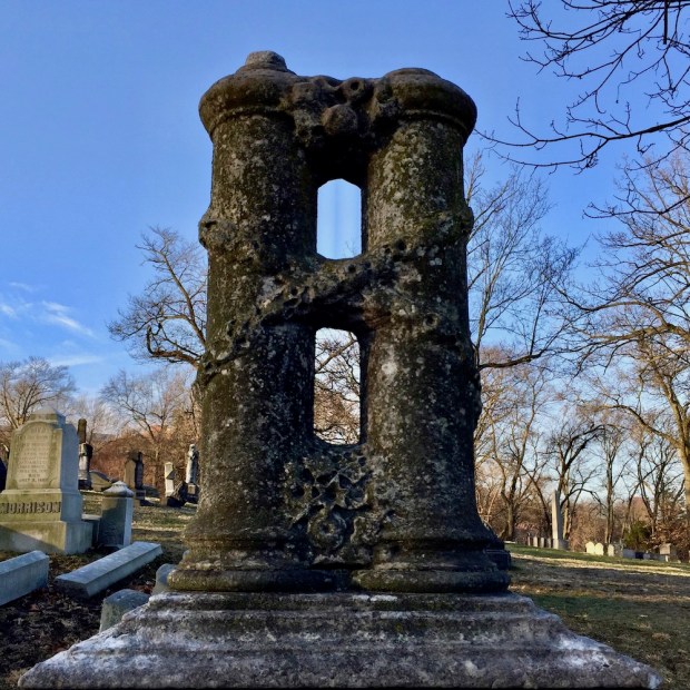 cemetery monument with unusual design featuring two columns connected by other material