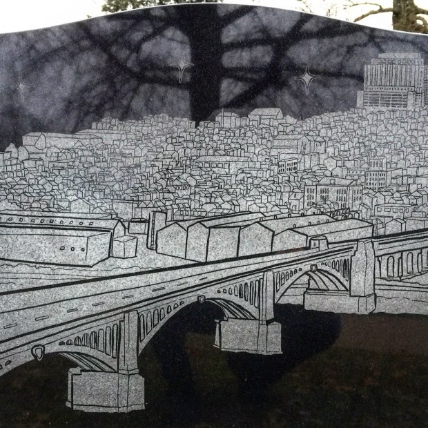grave marker with custom design depicting the Pittsburgh neighborhood of Lawrenceville as cartoonish line drawing