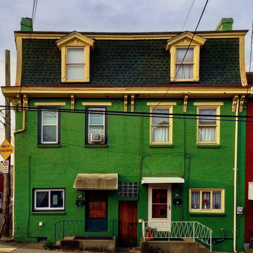 large row house painted bright green