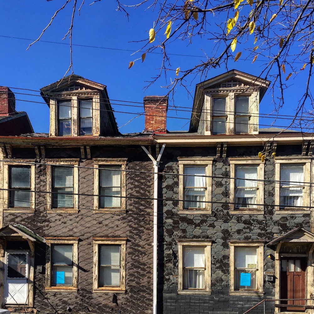 pair of row houses, each with gray shingled siding