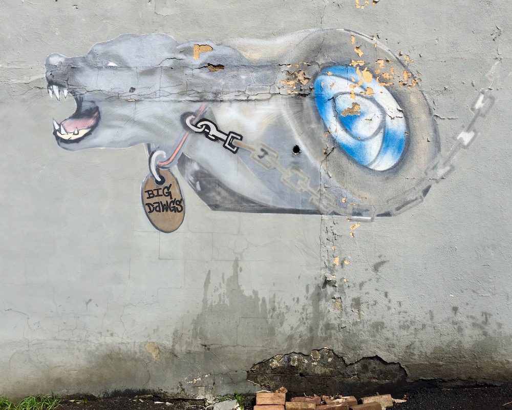 mural of dog's head fused onto speeding wheel