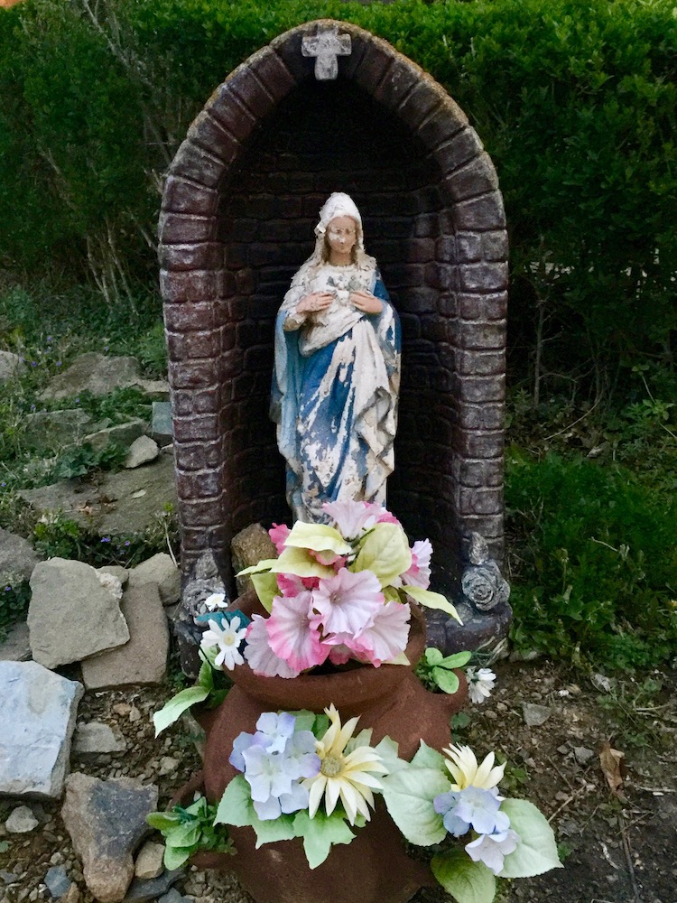 statue of Mary in front yard of house