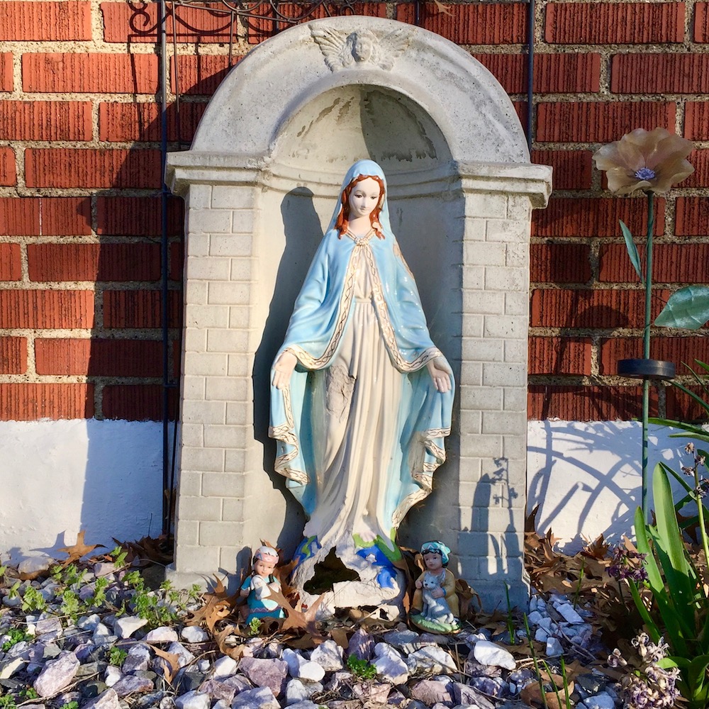 statue of Mary in front yard of house
