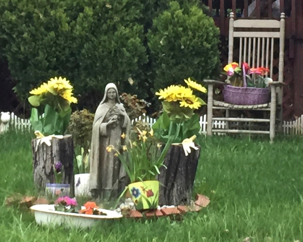 statue of nun in front yard of house