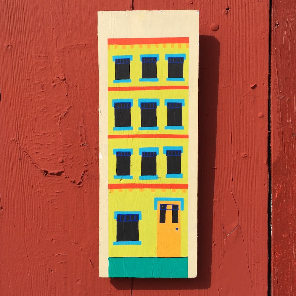 painting of building on wooden board
