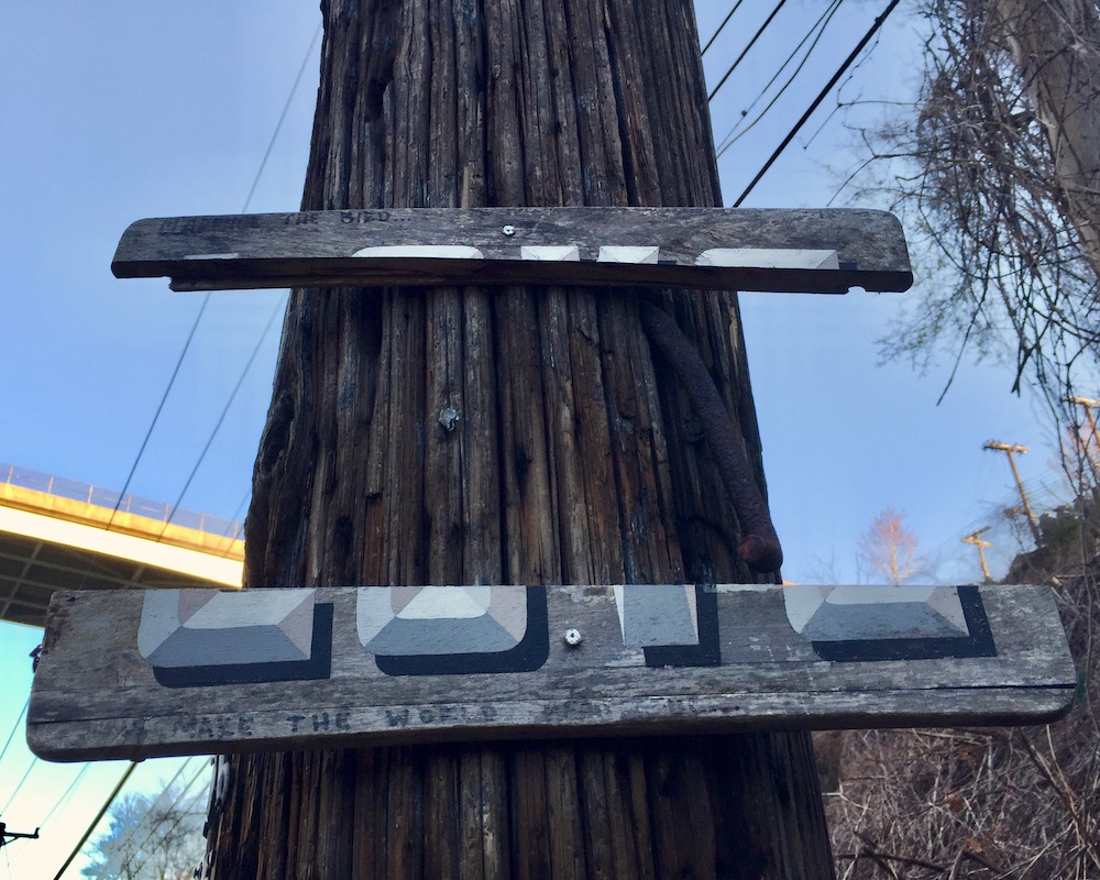 wooden painted board that used to read "LOVE" with most of the middle section removed