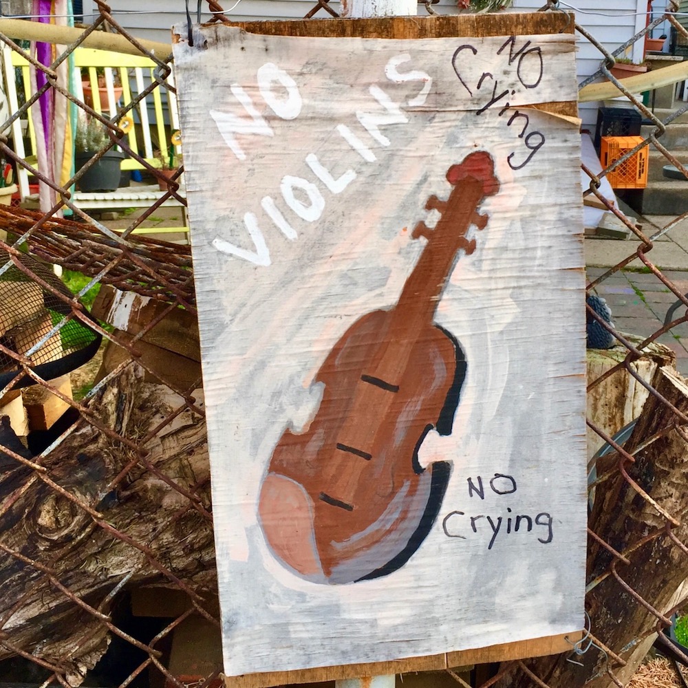 painting of violin with with words "No Violins" and "No Crying"