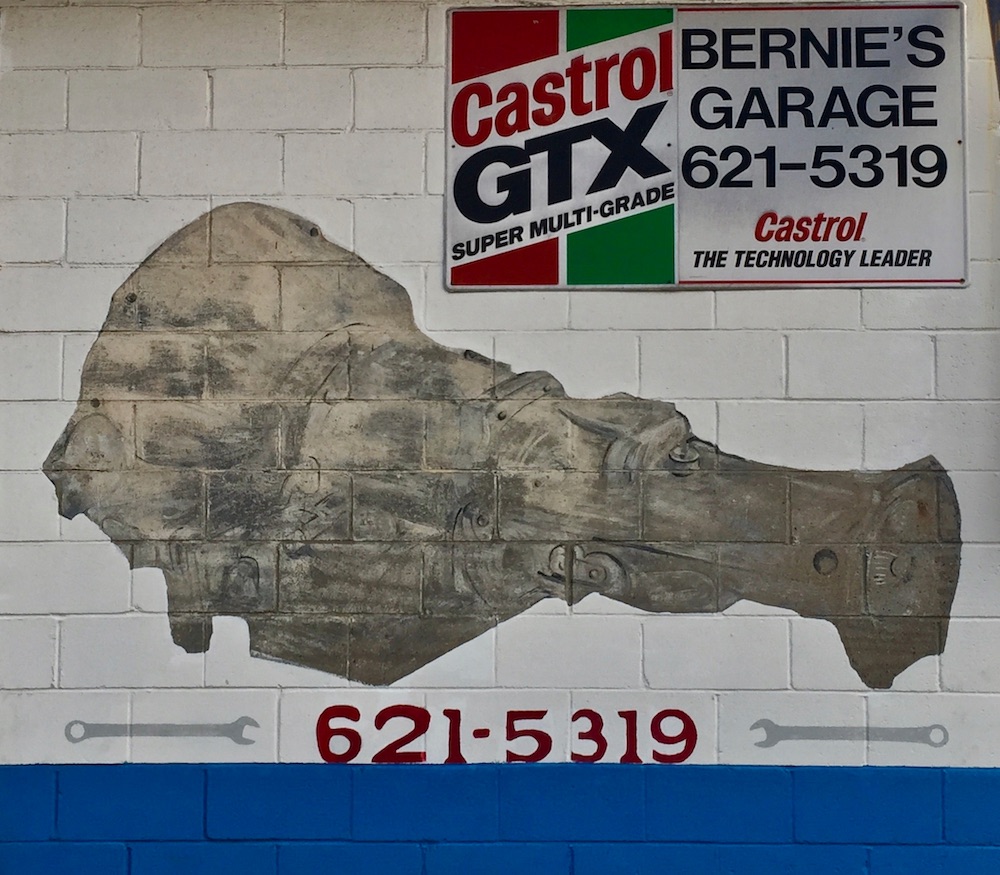mural of auto engine on exterior wall of garage