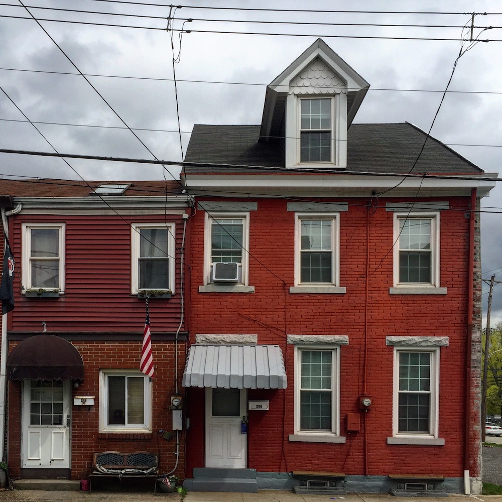pair of row houses, both painted in shades of red