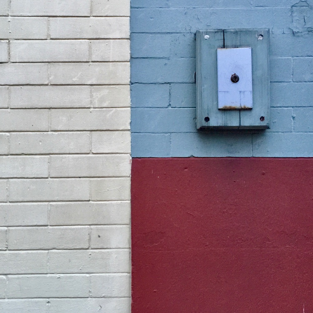 detail of brick retail storefronts where paint choices have made distinct geometric shapes