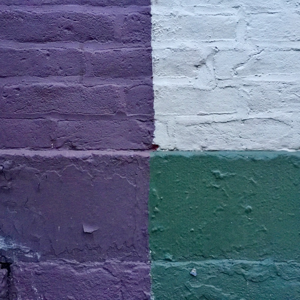detail of row houses where paint colors make four perfect squares