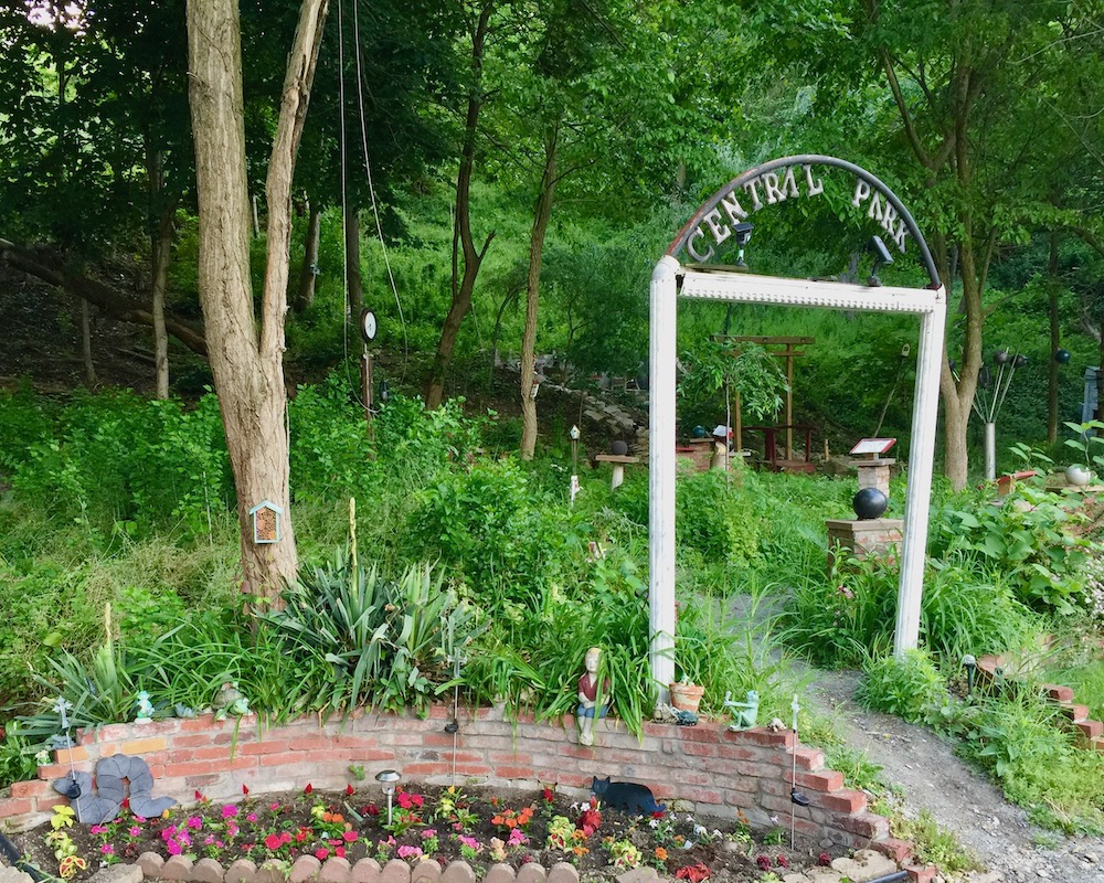 entrance to Pittsburgh's Central Park with ornamental gate and flower garden