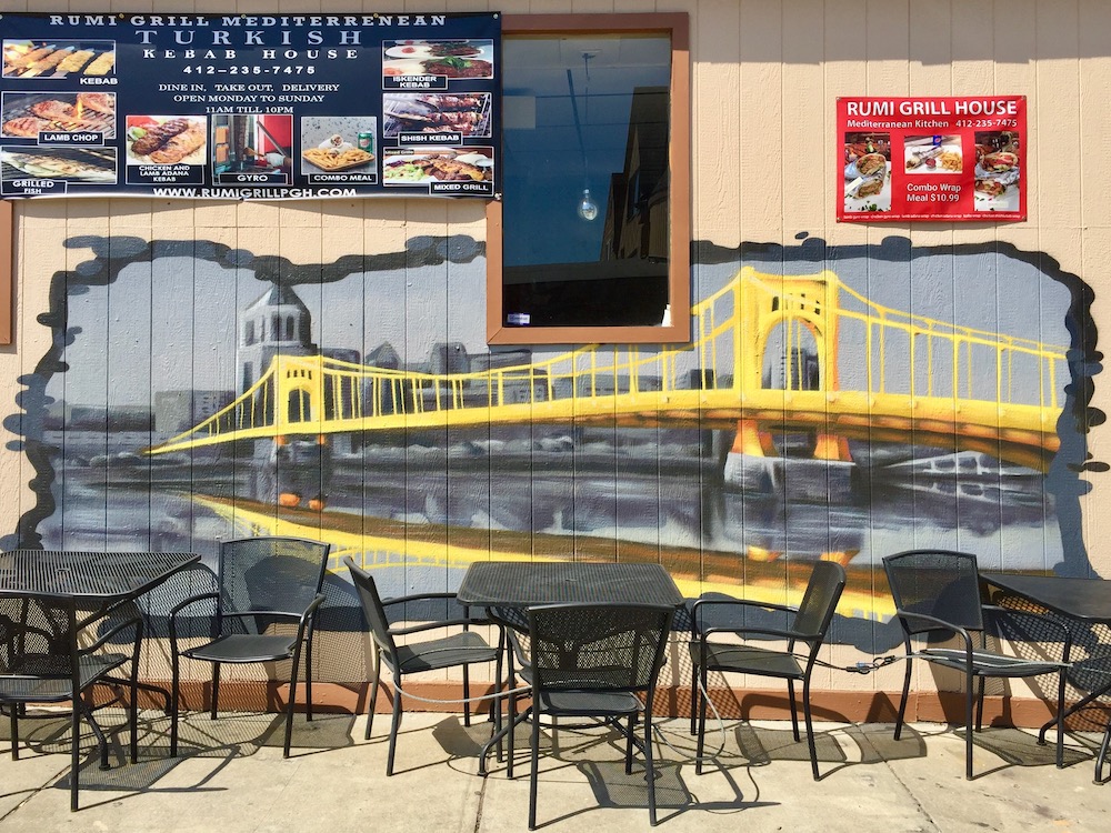 mural on restaurant's exterior wall showing bridge and downtown Pittsburgh skyline