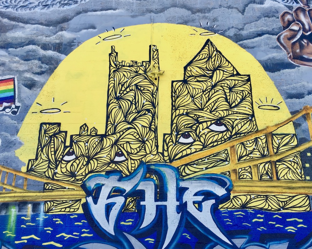 mural detail of downtown Pittsburgh buildings with eyes
