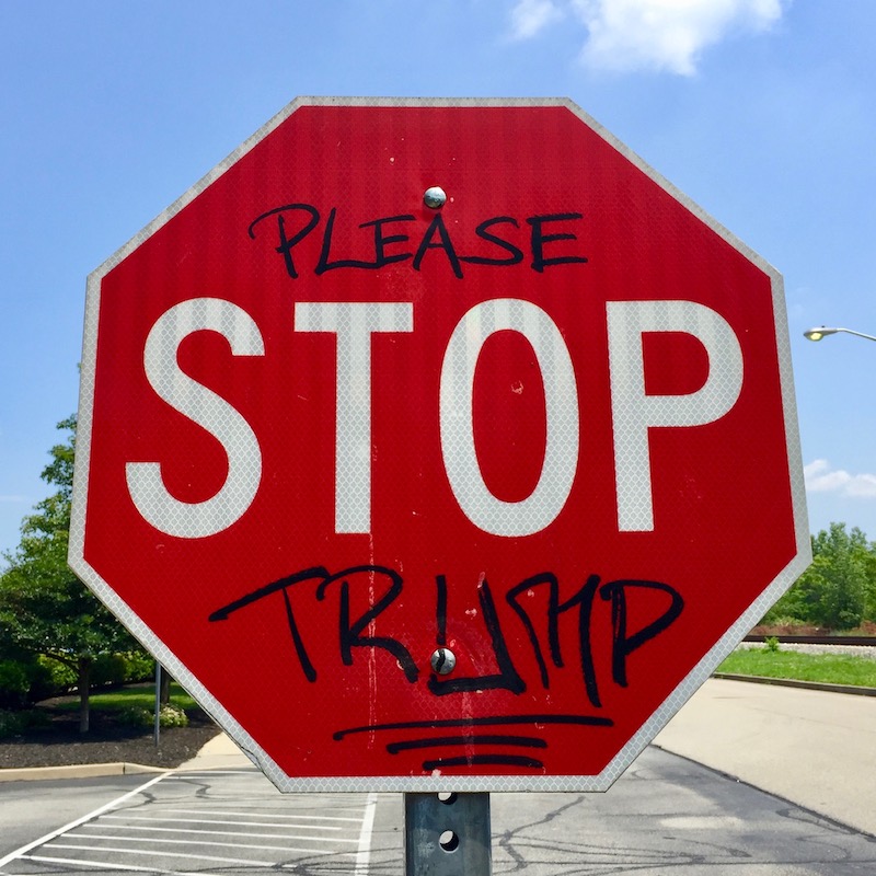 stop sign altered to read "Please stop Trump"
