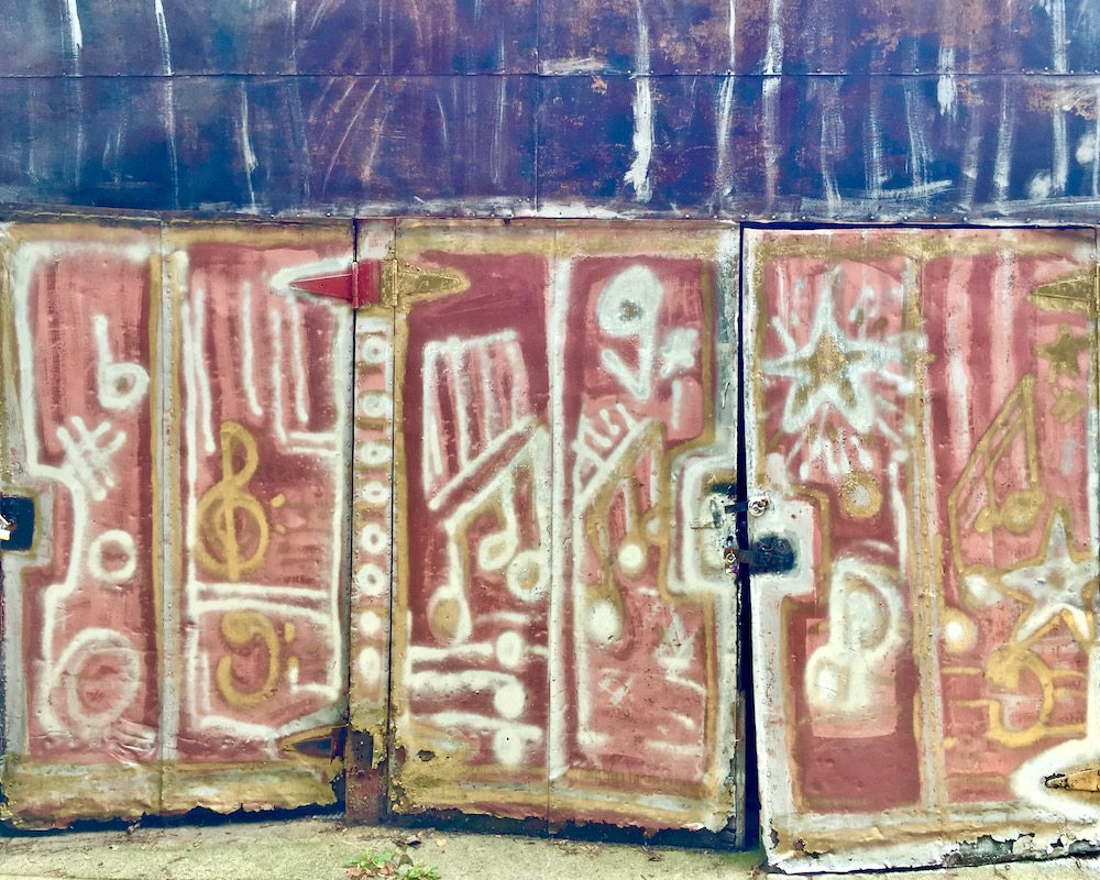 colorful abstract designs painted on metal shed doors