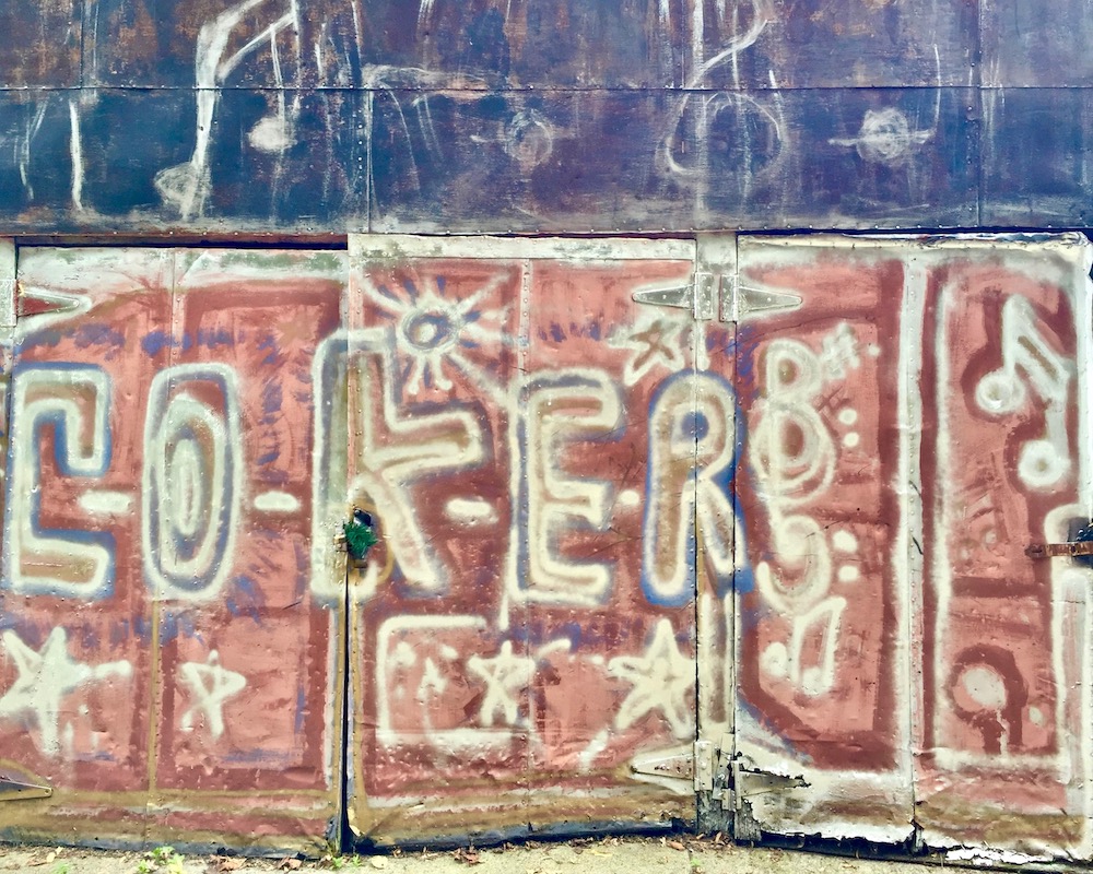 colorful abstract designs painted on metal shed doors