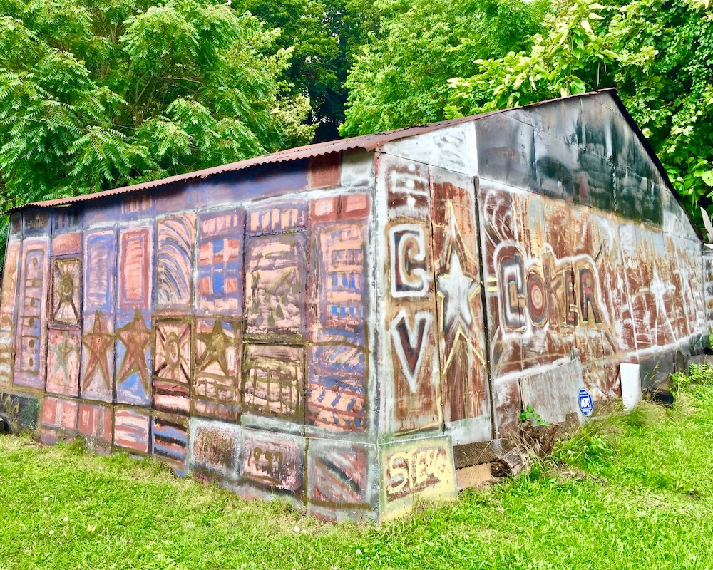 large metal shed painted in elaborate abstract panels