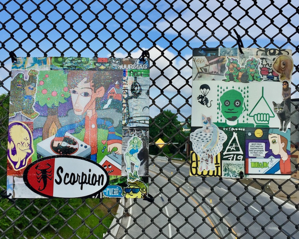 colorful collage of cartoon images, stickers, advertiments hung on chain link fence