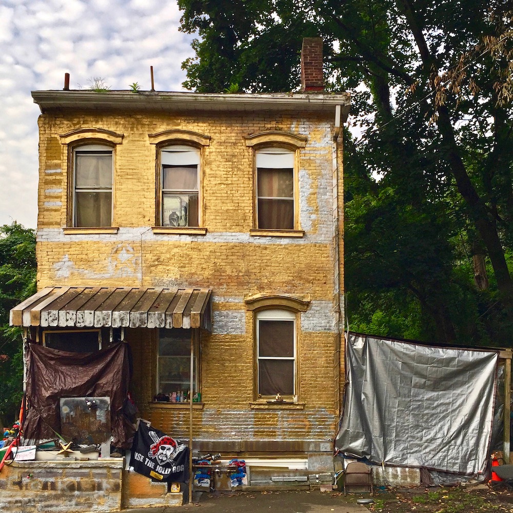 brick row house painted gold and silver