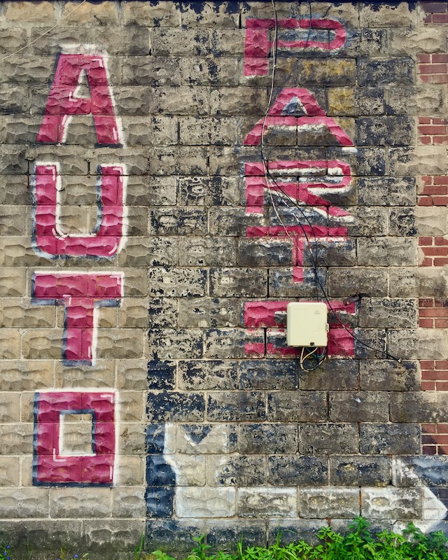 "Auto Parts" sign painted on masonry walllll
