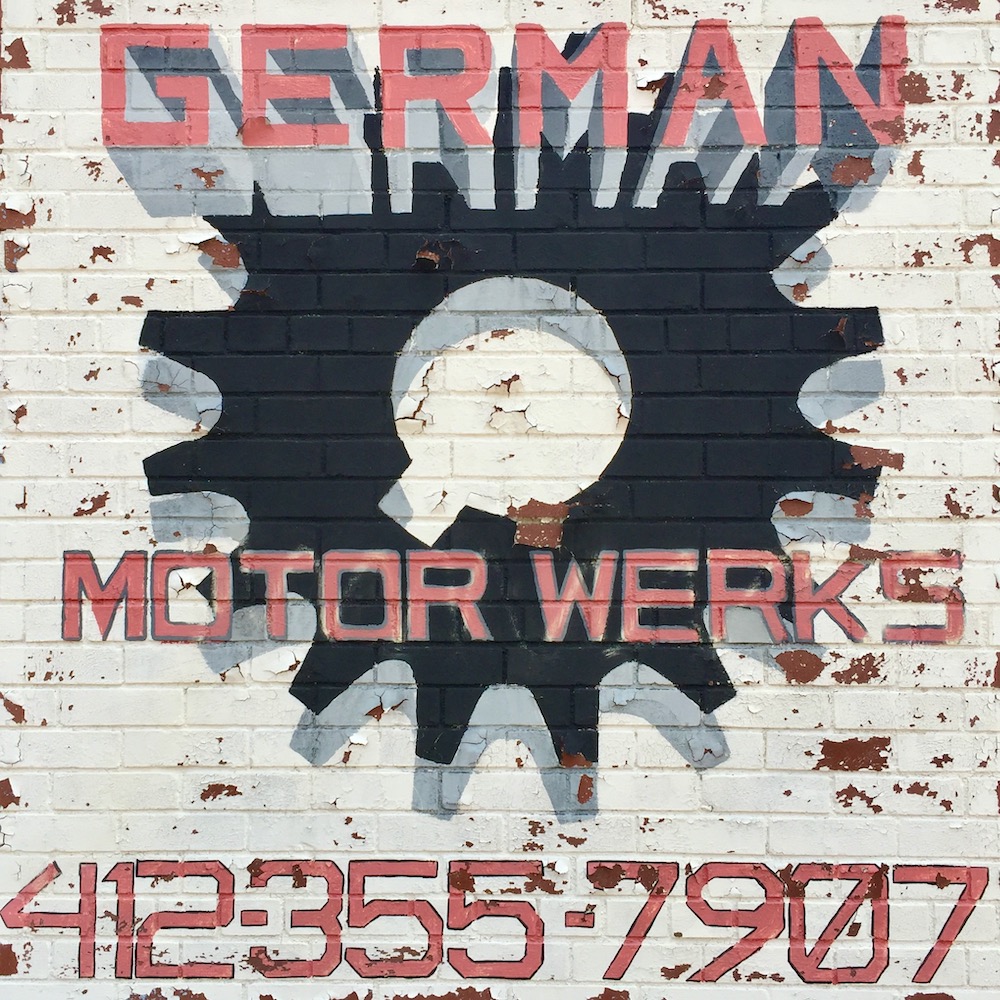 hand-painted sign for German Motor Werks including large gear