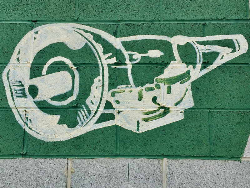 hand-painted mural of engine on cinderblock wall