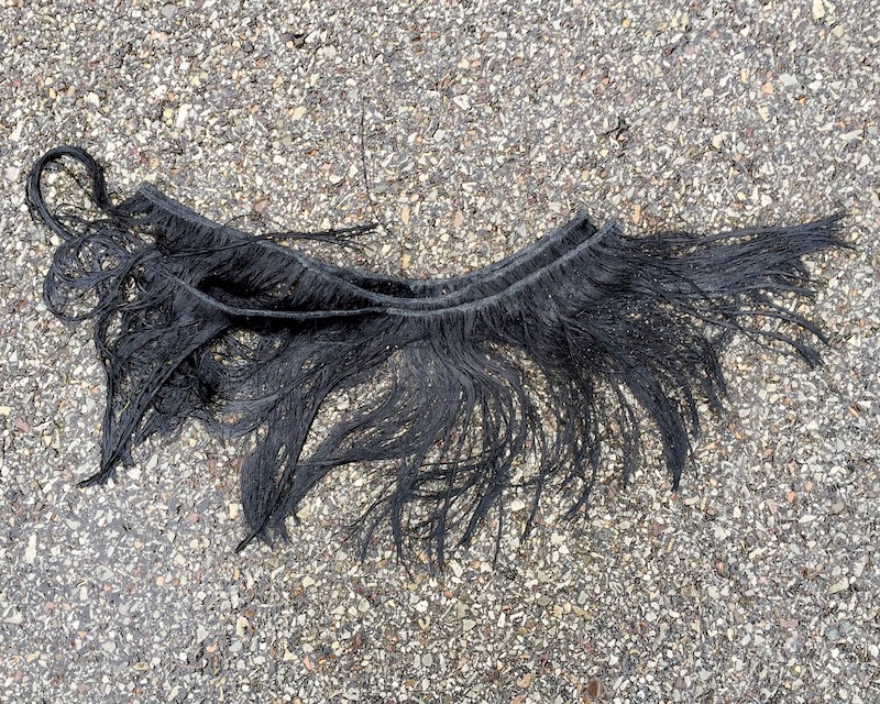 section of fake hair on road surface