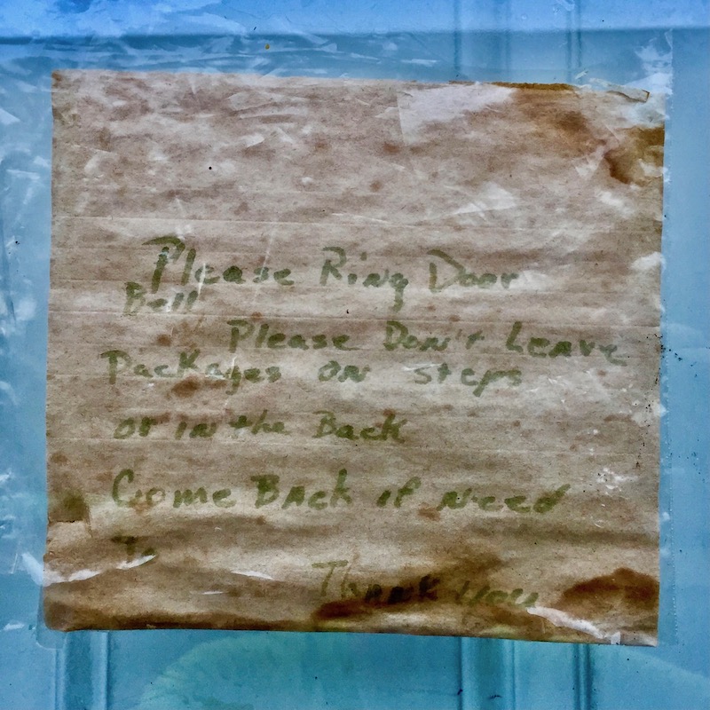 instuctions for mail and package delivery taped to front door of residence