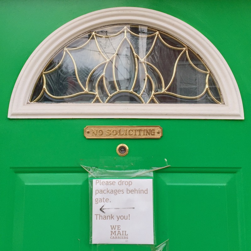 instuctions for mail and package delivery taped to front door of residence