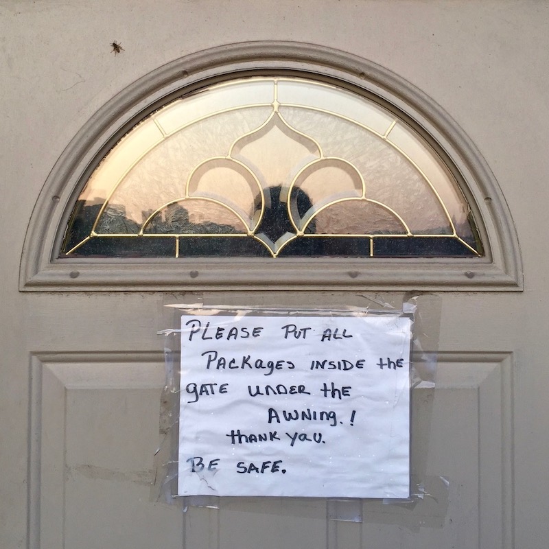 instuctions for mail and package delivery taped to front door of residence