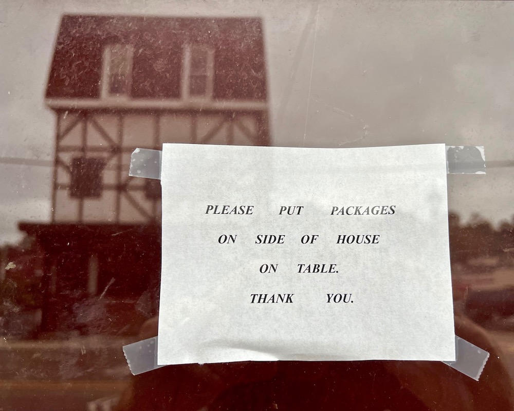 instuctions for mail and package delivery taped to front door of residence