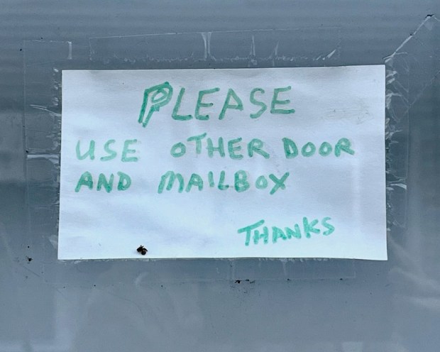 instuctions for mail and package delivery taped to front door of residence