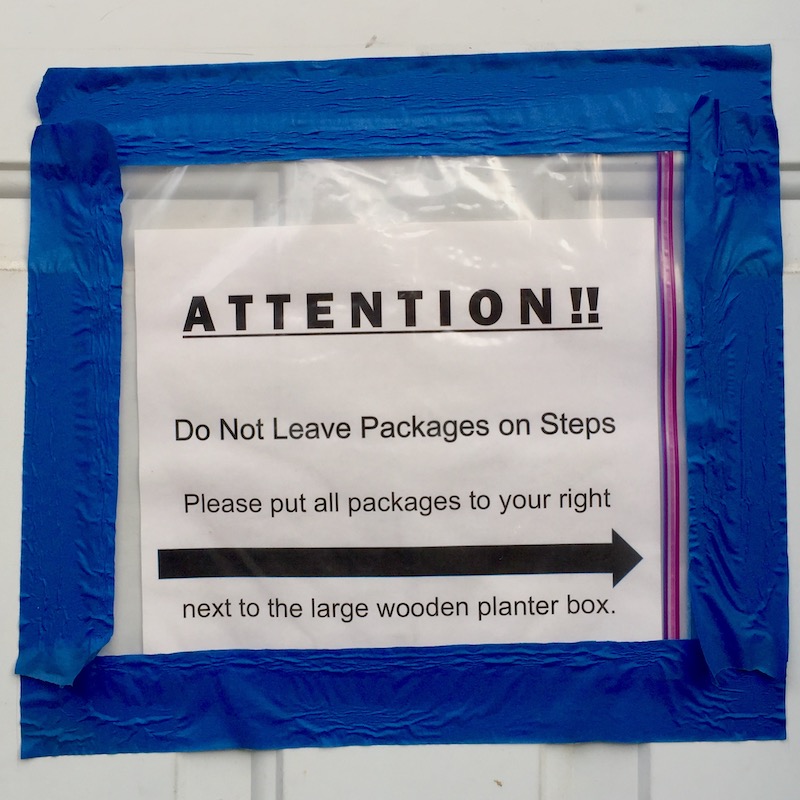 instuctions for mail and package delivery taped to front door of residence