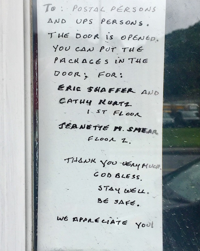 instuctions for mail and package delivery taped to front door of residence