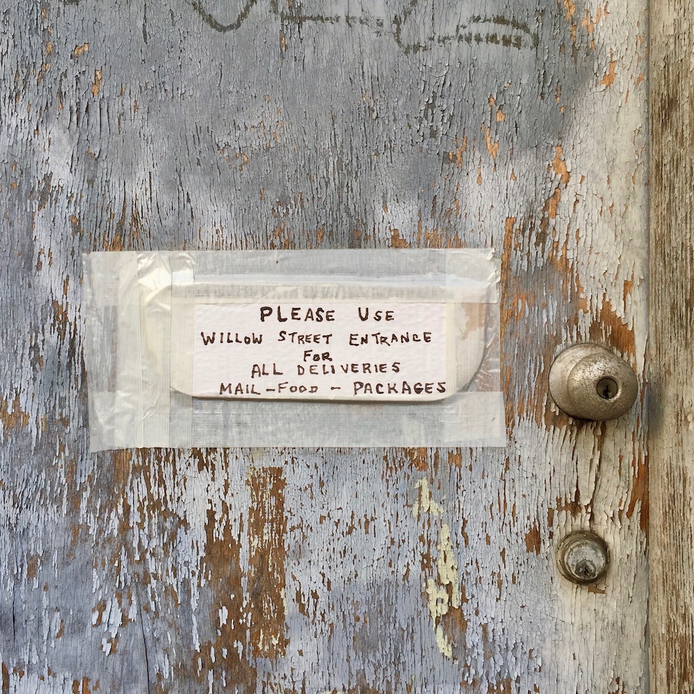 instuctions for mail and package delivery taped to front door of residence