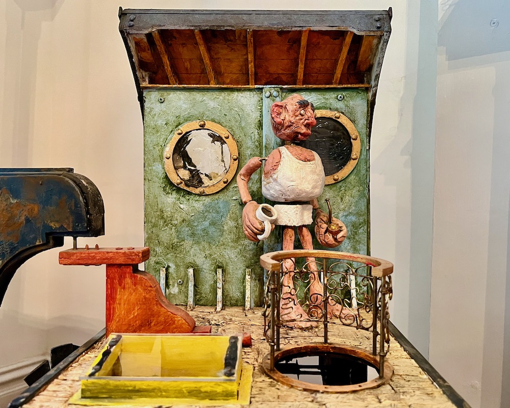 detail of automata artwork of older sailor onboard ship