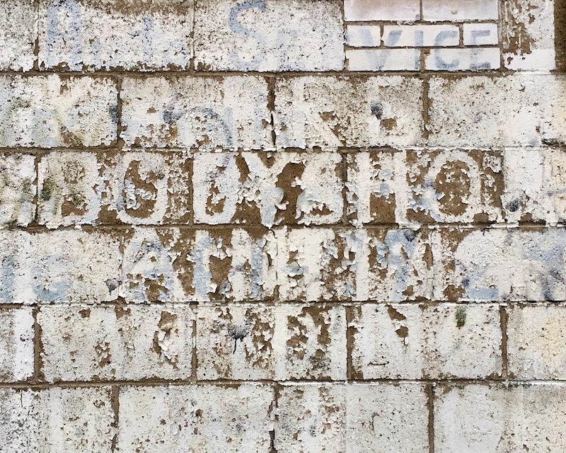 barely readable sign advertising bodyshop