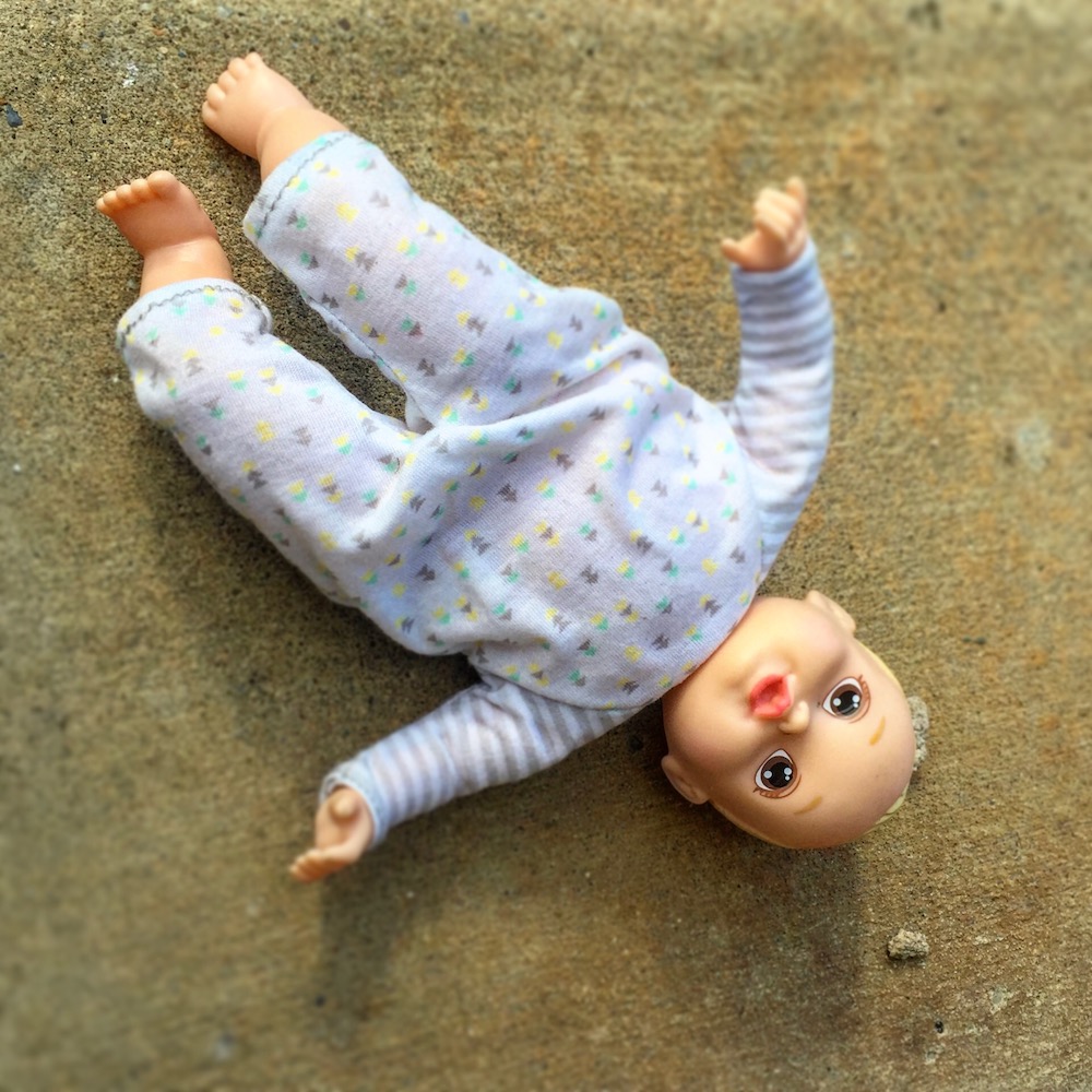 baby doll left on sidewalk