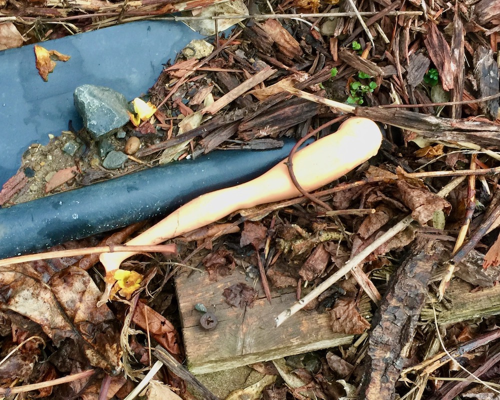 doll's leg in pile of debris