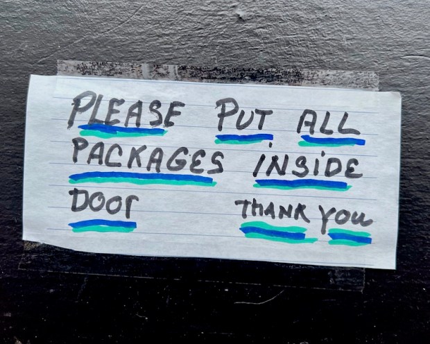hand-written instructions for package delivery taped to front door