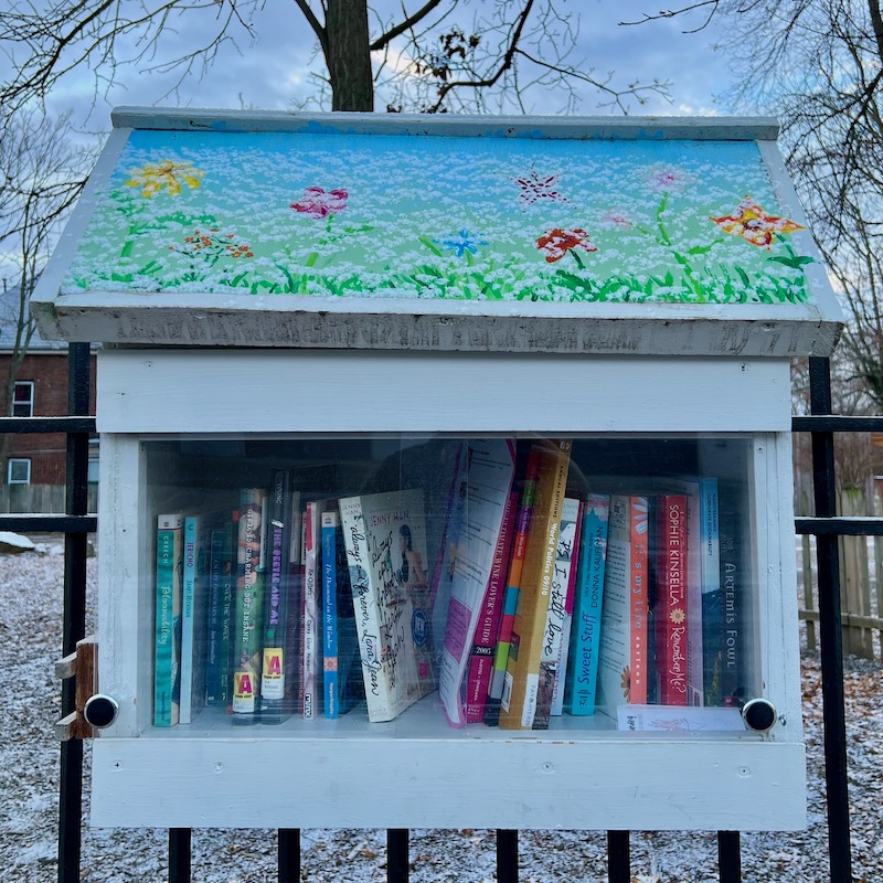 little free library painted with flower scene