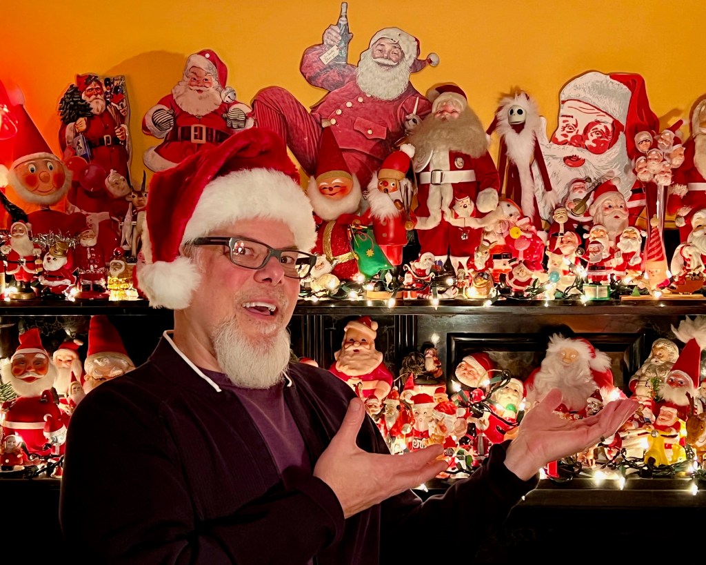 Santa collector Paul Schifino in front of a portion of his collection