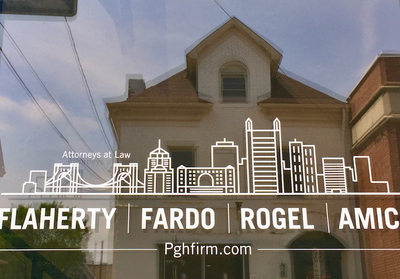 window decal for law firm including stylized image of downtown Pittsburgh skyline