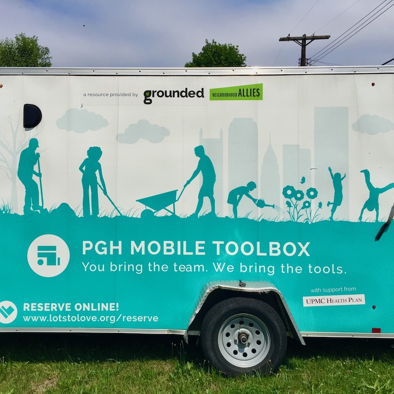box truck with background silhouette of the downtown Pittsburgh skyline
