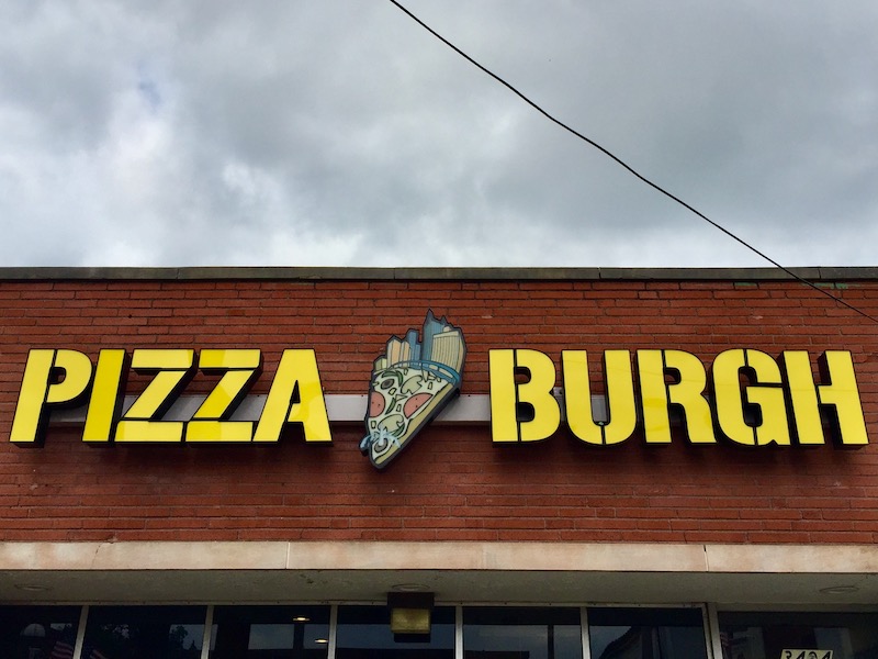 sign for Pizza Burgh including logo with slice of pizza and Pittsburgh skyline
