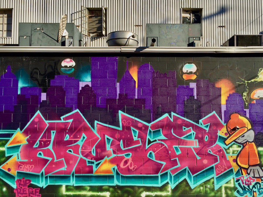 detail from mural featuring downtown Pittsburgh in shades of purple